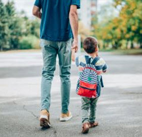 Photo of Father walking with child